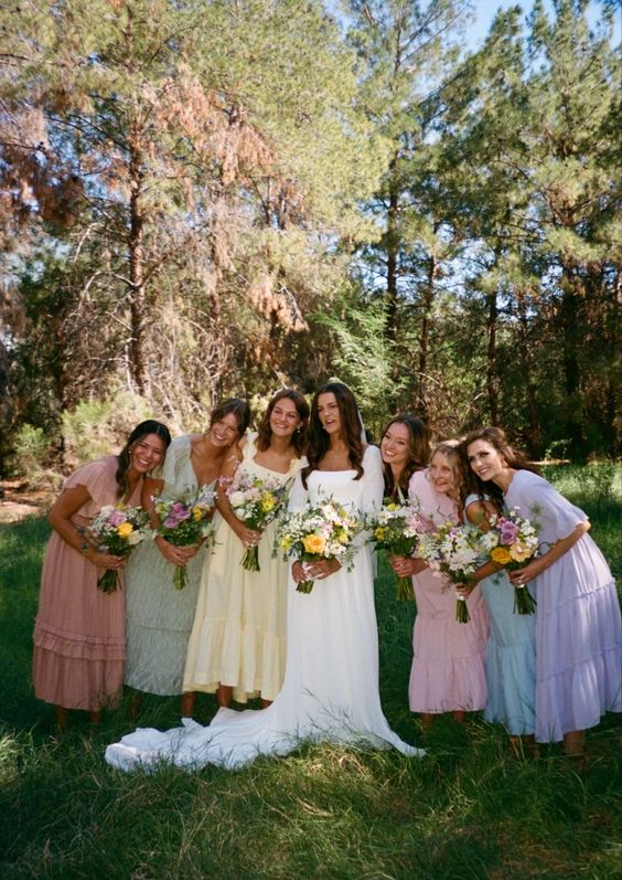 matching midi pastel bridesmaid dresses with short sleeves, in green, pink, lilac, blue and yellow are amazing for a spring or summer wedding