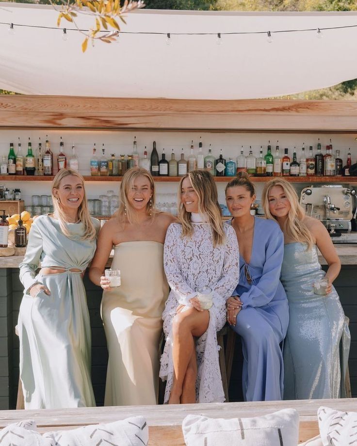 mismatching blue, aqua, yellow and periwinkle maxi bridesmaid dresses are perfect for a modern beach wedding