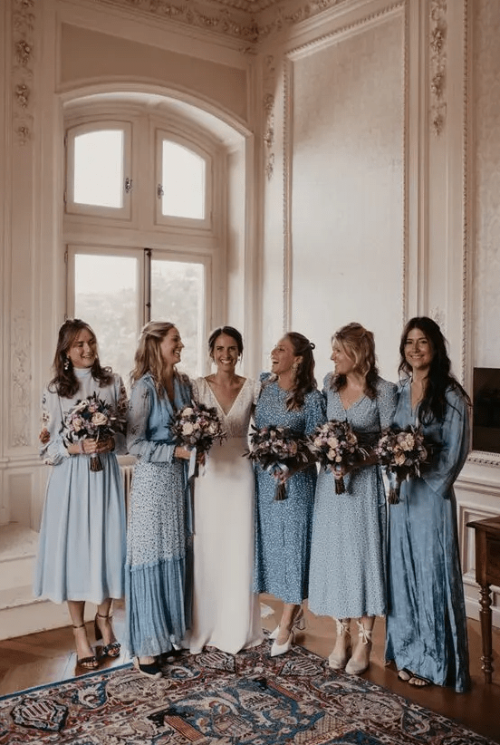 mismatching dusty blue printed and non-printed bridesmaid dresses of midi and maxi length, with long sleeves
