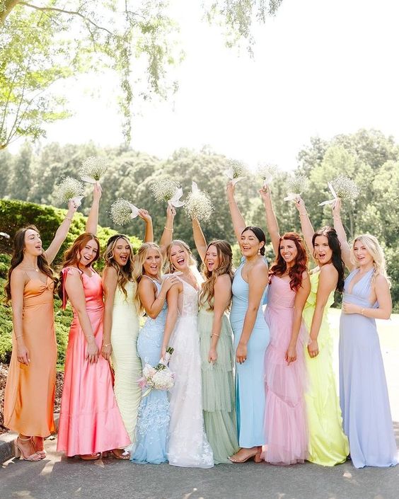 mismatching maxi pastel bridesmaid dresses with various silhouettes and detailing are great for a pastel wedding