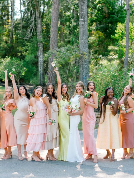 mismatching pastel pink, coral, yellow bridesmaid dresses plsu a neon yellow maid of honor one for a tropical wedding