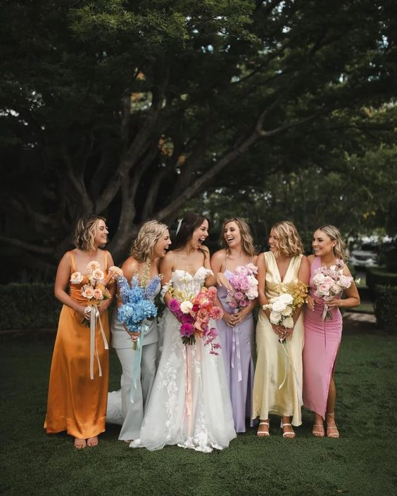 mix and match pastel maxi bridesmaid dresses and jumpsuits are adorable for a pastel spring or summer wedding