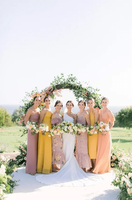 pastel maxi and midi bridesmaid dresses in coral, yellow and mauve for a sophisticated spring wedding