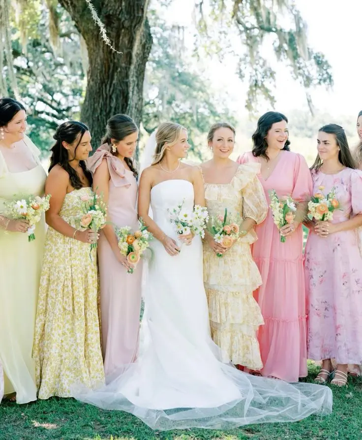 Pastel printed and solid yellow and pink maxi bridesmaid dresses are amazing for a color infused summer wedding