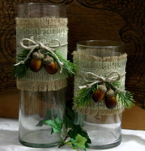glass candleholders with burlap, acorns and evergreens are lovely for rustic wedding decor in the fall and winter