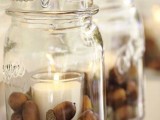 hanging jars with acorns and candleholders inside are great to illuminate your wedding venue for your fall wedding