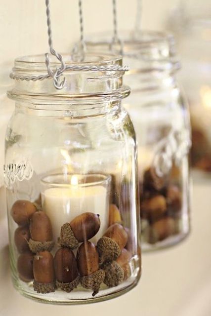 hanging jars with acorns and candleholders inside are great to illuminate your wedding venue for your fall wedding