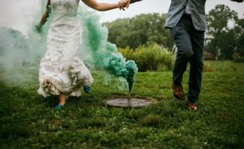 a green smoke bomb echoes with the wedding shoes and adds eye-catchiness to the backdrop