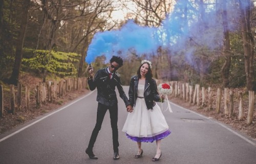 a fun wedding portrait on the road, with a blue smoke bomb that adds a badass feel to the couple