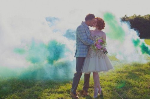 green smoke bombs as a bold and catchy wedding backdrop for a first married iss