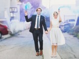 blue and purple smoke bombs made the space behind a creative and cool backdrop for a wedding portrait