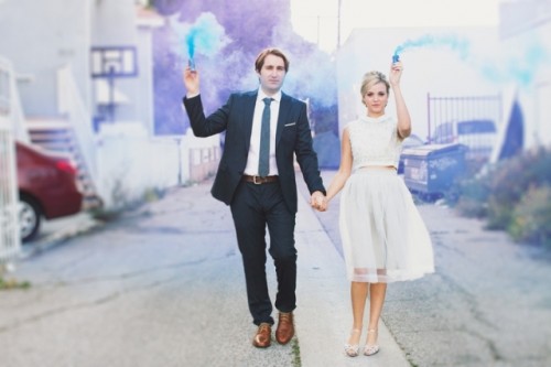 blue and purple smoke bombs made the space behind a creative and cool backdrop for a wedding portrait