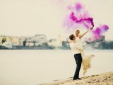 a lovely beach wedding portrait done with a purple smoke bomb looks very bold, catchy and very cool