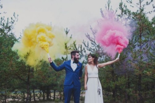 a wedding portrait done in the forest, with bright yellow and pink smoke bombs is a fun and cool idea