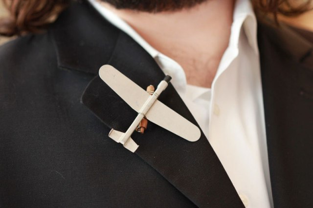 a mini airplane boutonniere for a plane loving or pilot groom is stylish and cute
