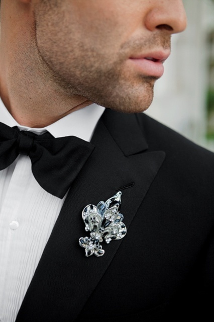 a refined French lily wedding boutonniere with neutral and black rhinestones is a chic and bold accessory