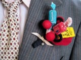 a colorful candy and pompom wedding boutonniere with a ribbon wrap is a nice and fun idea to try