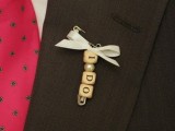 a scrubble wedding boutonniere with a pin, a bead and a ribbon bow is lovely and easy to DIY