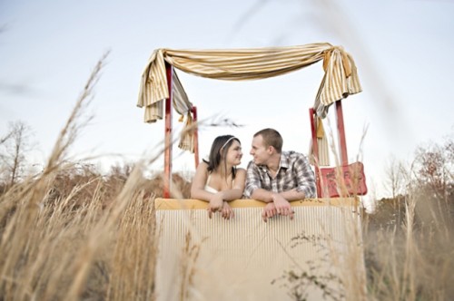 a simple and neutral wedding kissing booth with neutral striped fabric for decor is great for a casual wedding