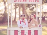 a simple and bright kissing booth with a sign styled in a retro way is a cool idea for fun