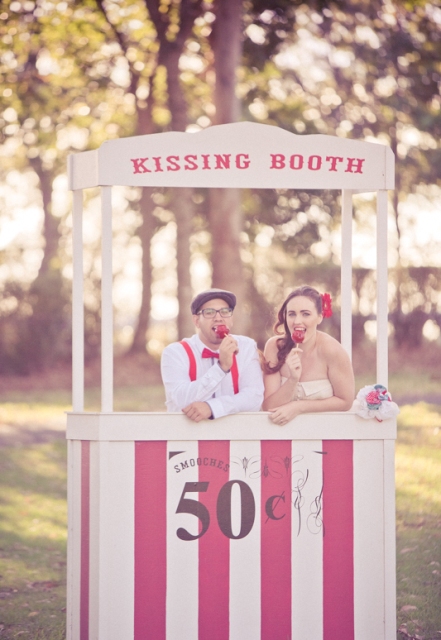 a simple and bright kissing booth with a sign styled in a retro way is a cool idea for fun