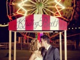 a brigth striped kissing booth placed strategically to create a cool and fun wedding backdrop