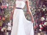 a beautiful A-line wedding dress with a lace bodice with short sleeves and a pleated skirt plus an embellished belt