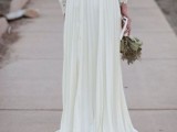 a beautiful vintage-inspired wedding dress with a plain and lace bodice with long sleeves and a pleated skirt with a train is a gorgeous idea