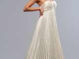 a gorgeous A-line pleated wedding dress with a pleated bodice and straps going up is a chic and bold idea