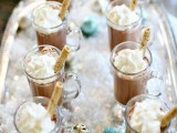 a tray with hot chocolate, ornaments and fake snow is a very cute idea for a winter wedding