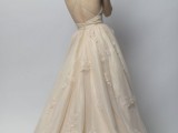 an ivory wedding ballgown with floral lace appliques, an open back, spaghetti straps and an open back and a train