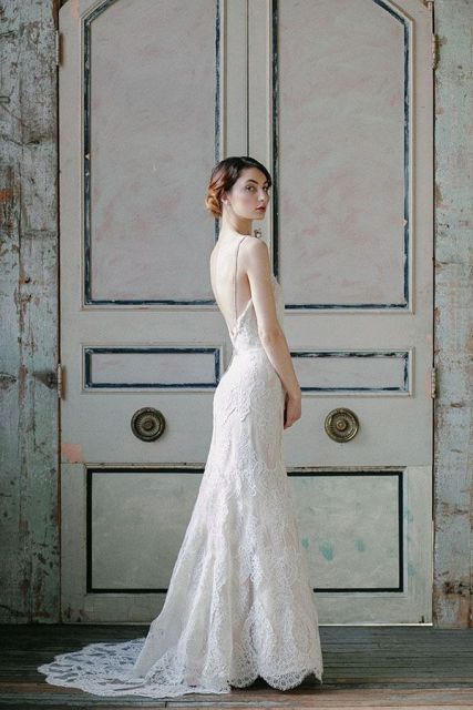 a full lace fitting wedding dress with spaghetti straps, an open back and a train is very chic
