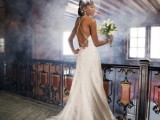 a white lace A-line wedding dress with spaghetti straps and an open back looks romantic