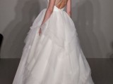 a wedding ballgown with an open back, criss cross spaghetti straps and a full layered skirt with a train