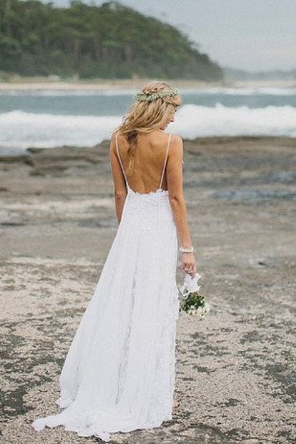 a lace A-line spaghetti strap wedding dress with an open back is a romantic and stylish gown