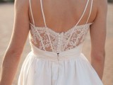 a gorgeous A-line spaghetti strap A-line wedding dress with a pleated full skirt, a lace back on buttons is wow