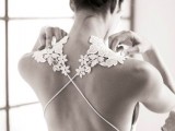 a sleek plain sheath wedding dress with floral applique straps and an open criss cross back