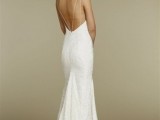 a fitting lace embellished wedding dress with spaghetti straps and an open back, a small train for a chic bridal look