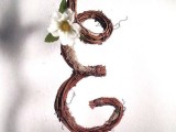 a vine monogram with a single white bloom is a creative and cool wedding cake topper to try