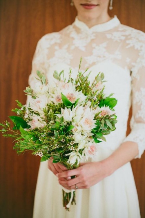 a small textural wedding bouquet with greenery, twigs and some blush blooms is a delicate idea for a spring or summer bride