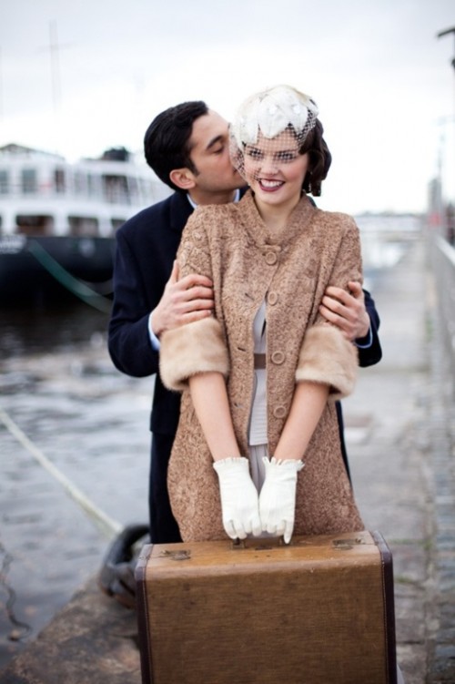 a vintage bridal look with a faux fur coat, a birdcage veil and elegant white vintage gloves with ruffles