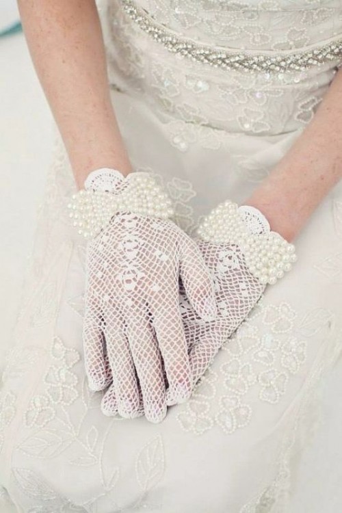 white crocheted gloves with pearl bows are a refined and elegant accessory for a vintage bride