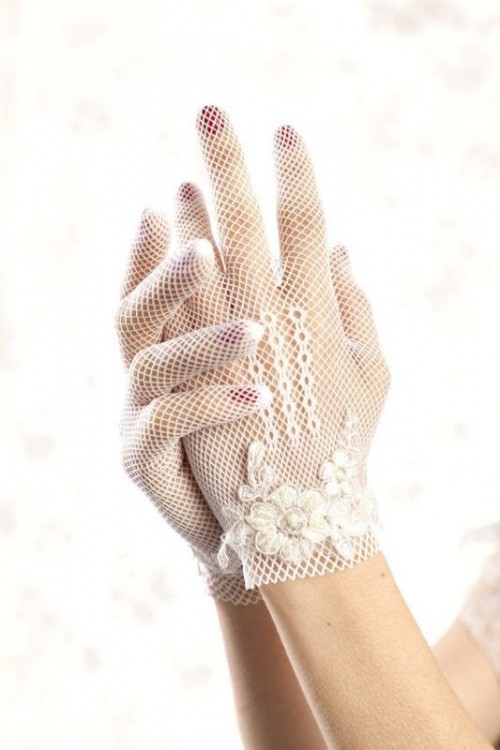 white crochet gloves with crocheted flowers are a delicate and chic accessory for a vintage bride
