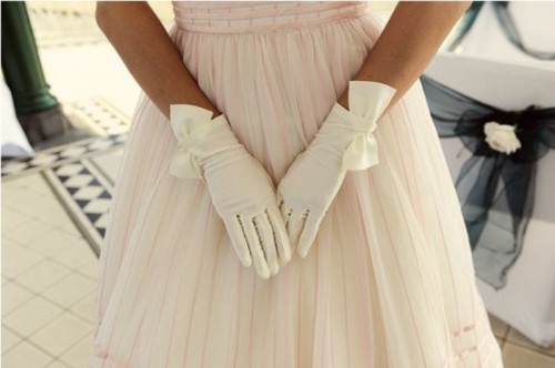 white draped gloves with large bows will add a retro touch to the look and more chic