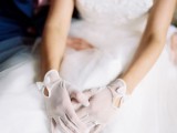 semi sheer white bridal gloves with cutouts and bows look very refined, romantic, this is a modern take on classics