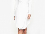 an ultra-minimalist white plain over the knee wedding dress with a high neckline and long sleeves for a minimalist bride