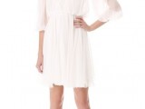 a white draped mini wedding dress with a heavily embellished neckline and shoulders for a modern glam bride
