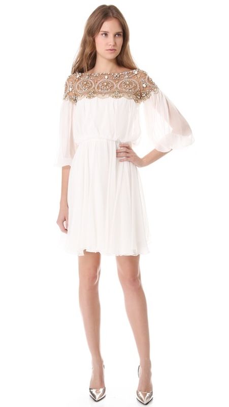 a white draped mini wedding dress with a heavily embellished neckline and shoulders for a modern glam bride