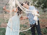 an oversized dream catcher with long ropes is a cool and creative decoration for a boho wedding today