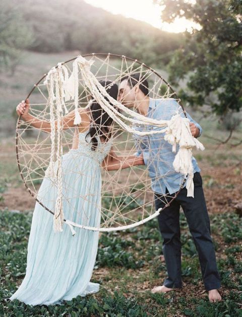 An oversized dream catcher with long ropes is a cool and creative decoration for a boho wedding today